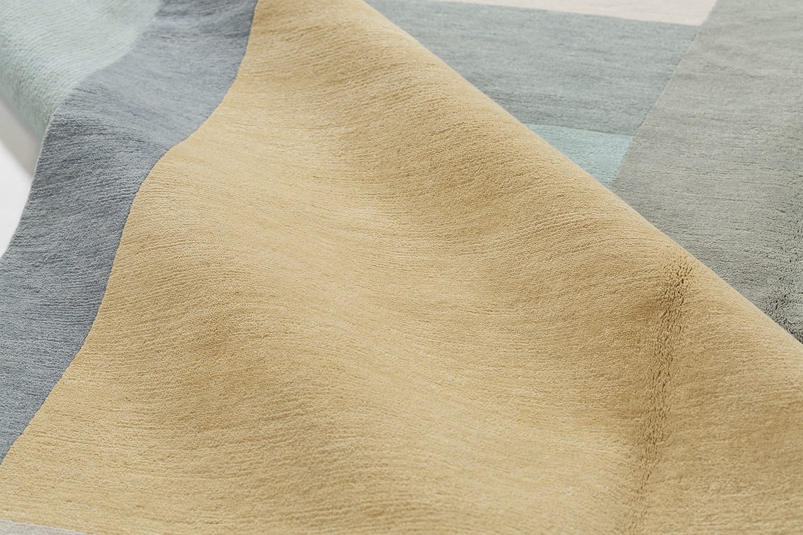 detail image of Monolith Light Blue hand knotted area rug design by Tufenkian